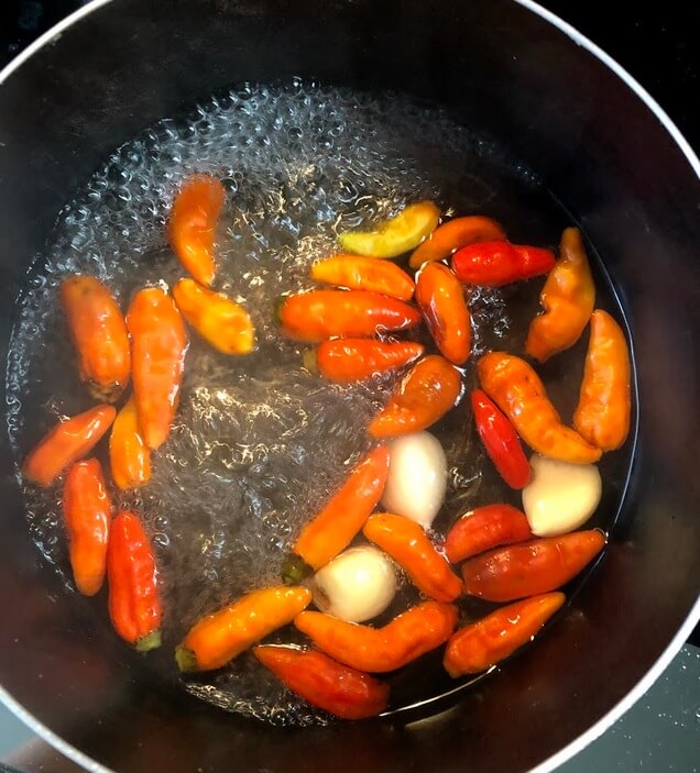 Boiling the chillies and garlic